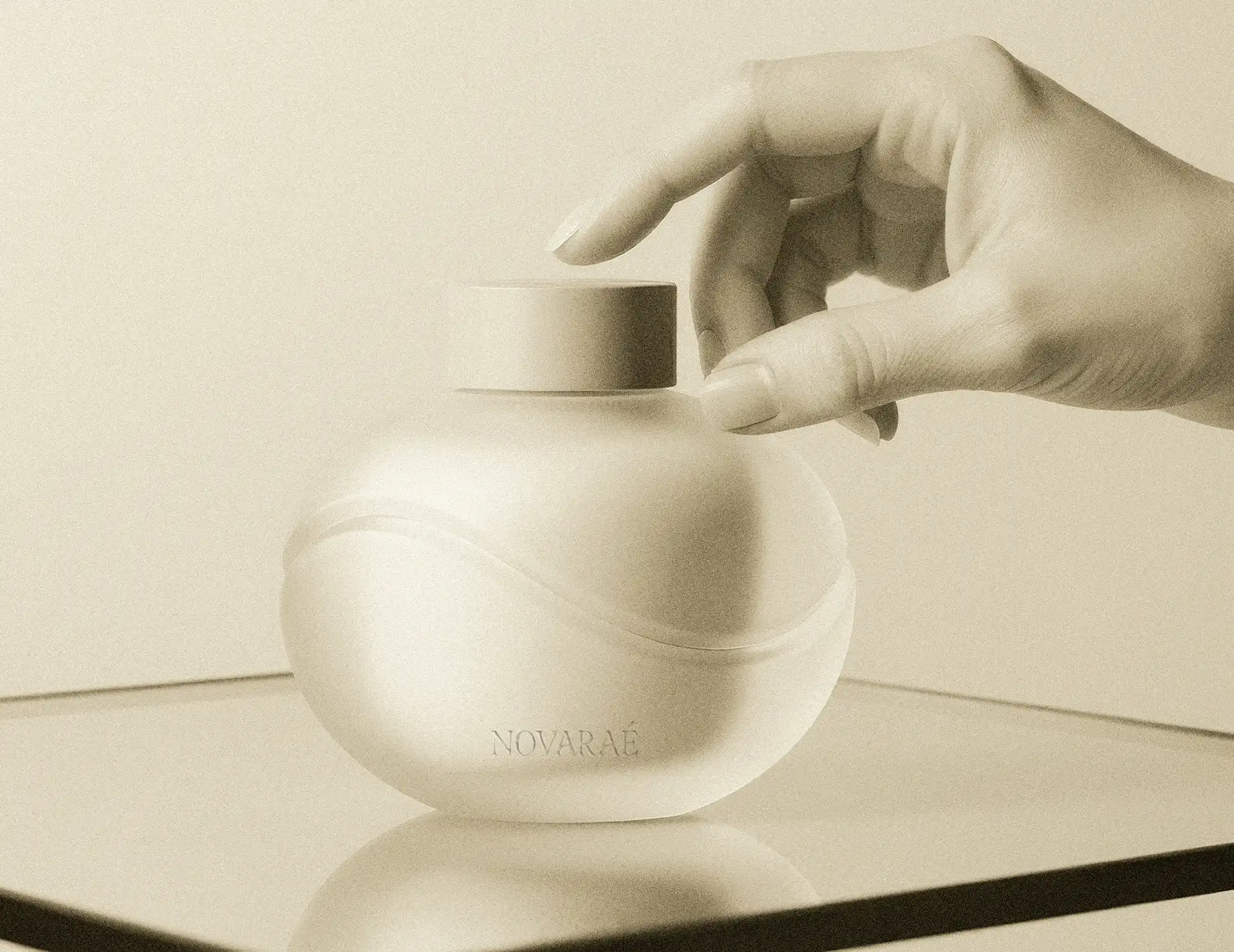 Branded product packaging for Novarae haircare brand showing logo on frosted glass jar